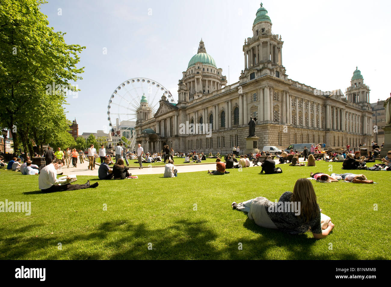 workers enjoy lunch in the sunshine Belfast City Hall Ulster Northern Ireland Stock Photo