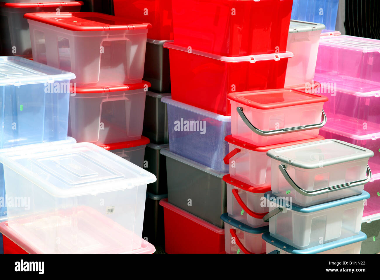 Plastic storage boxes on display outside hardware shop, England Stock