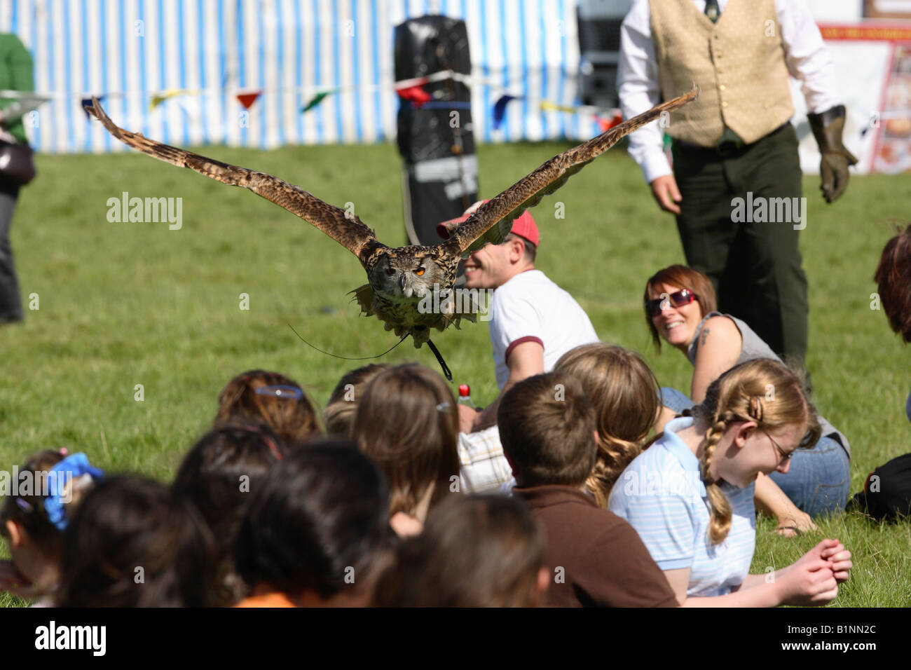 Eagle Owl Flying over Children Stock Photo