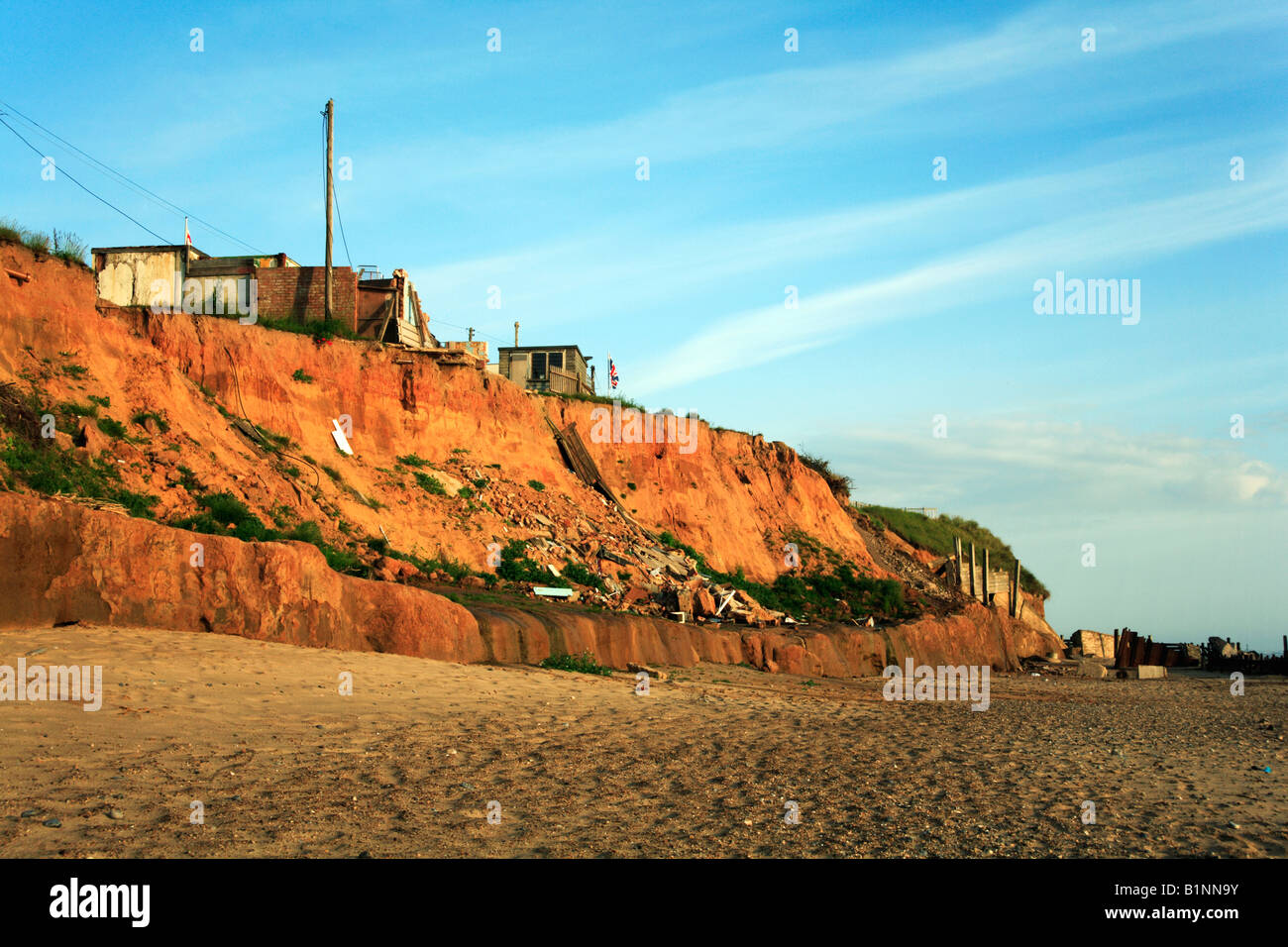 Property at Happisburgh, Norfolk, UK, falling to the beach as a result ...