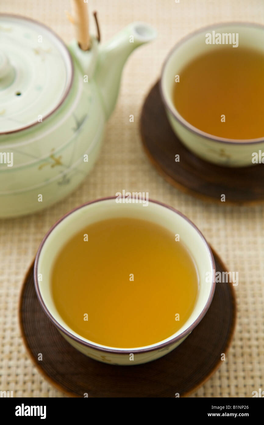 Japanese style tea cups filled with tea Stock Photo - Alamy