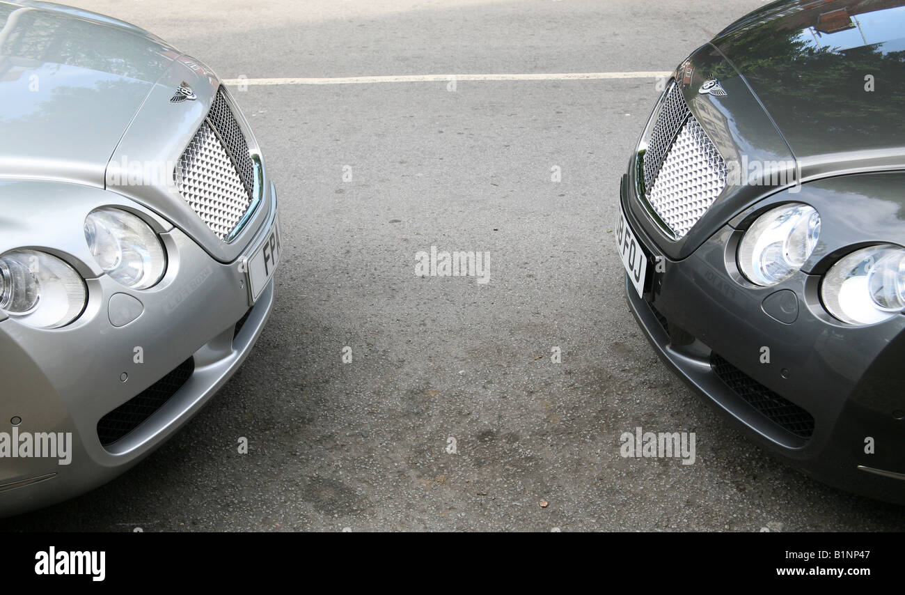 Two Bentley luxury cars parked nose to nose in London street Stock Photo