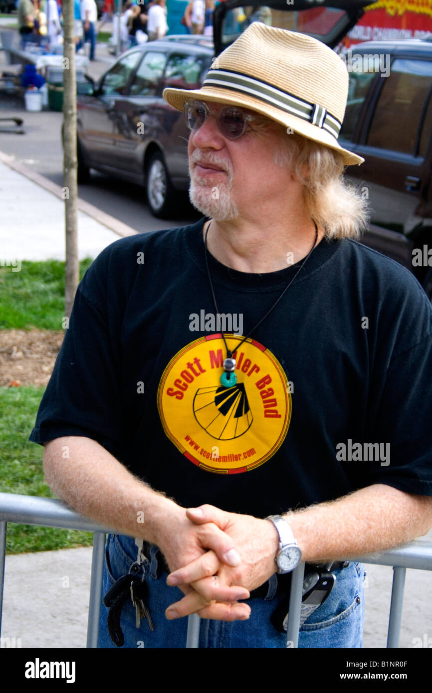 Man age 50 with straw hat totally enjoying the music of the Scott Miller Band. Grand Old Day Street Fair St Paul Minnesota USA Stock Photo