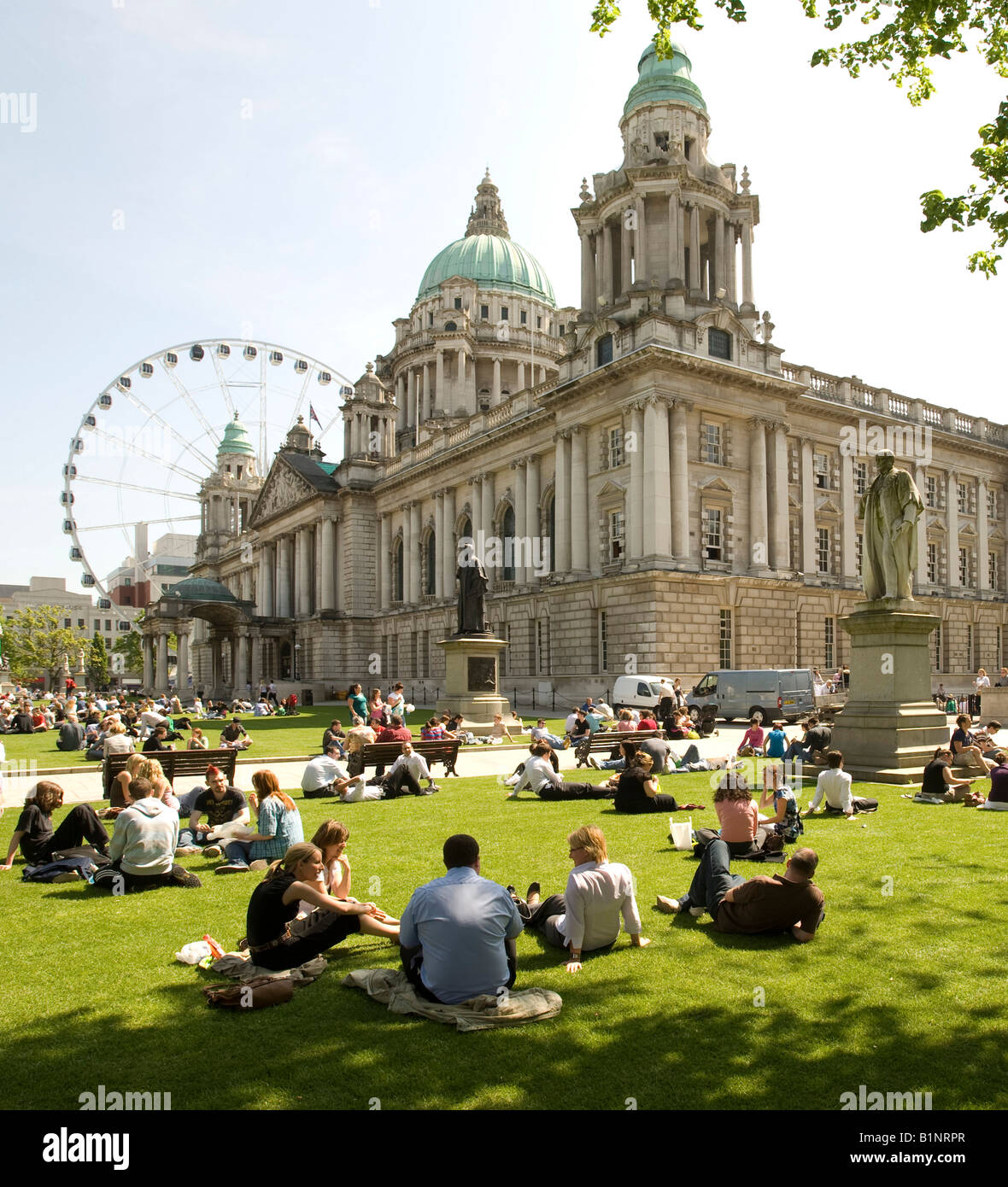 workers enjoy lunch in the sunshine Belfast City Hall Ulster Northern Ireland Stock Photo
