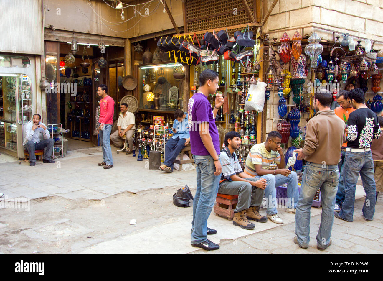 Young arab men congregate on a street corner in the Khan El Khalili market in Cairo Egypt Stock Photo