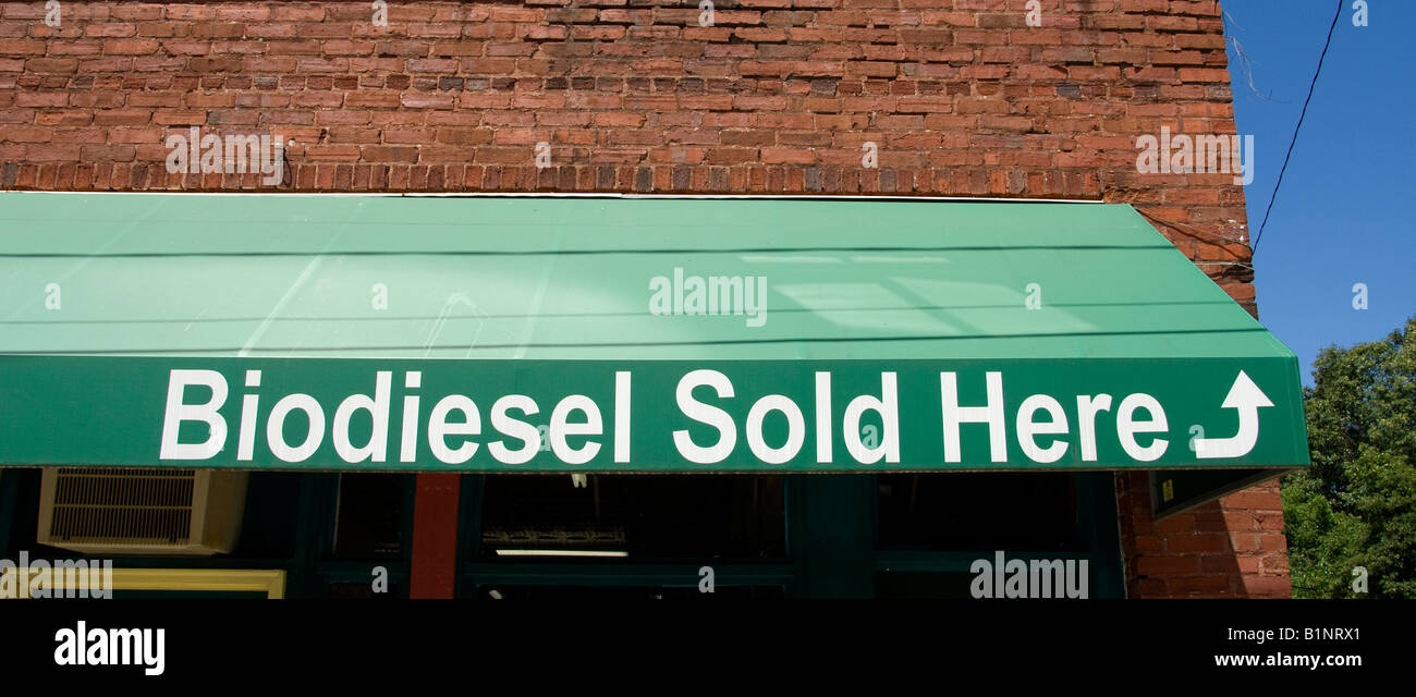 green "Biodiesel Sold Here" sign on an awning of retail space showing