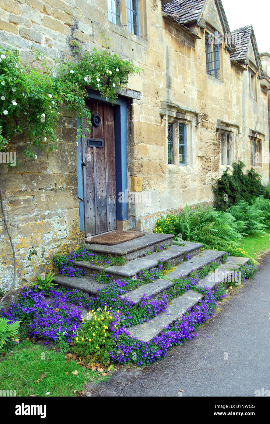 Doorstep and entrance to Cotswold Stone cottage, Stanton, The Cotswolds, Gloucestershire UK Stock Photo