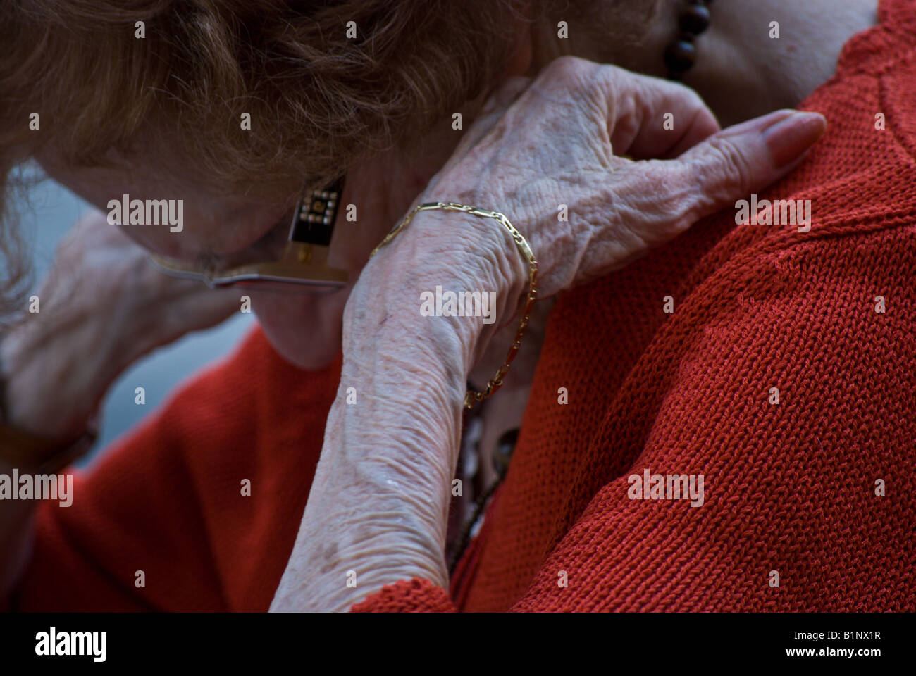 Senior woman with head bent. appears to be in lost in thought Stock Photo