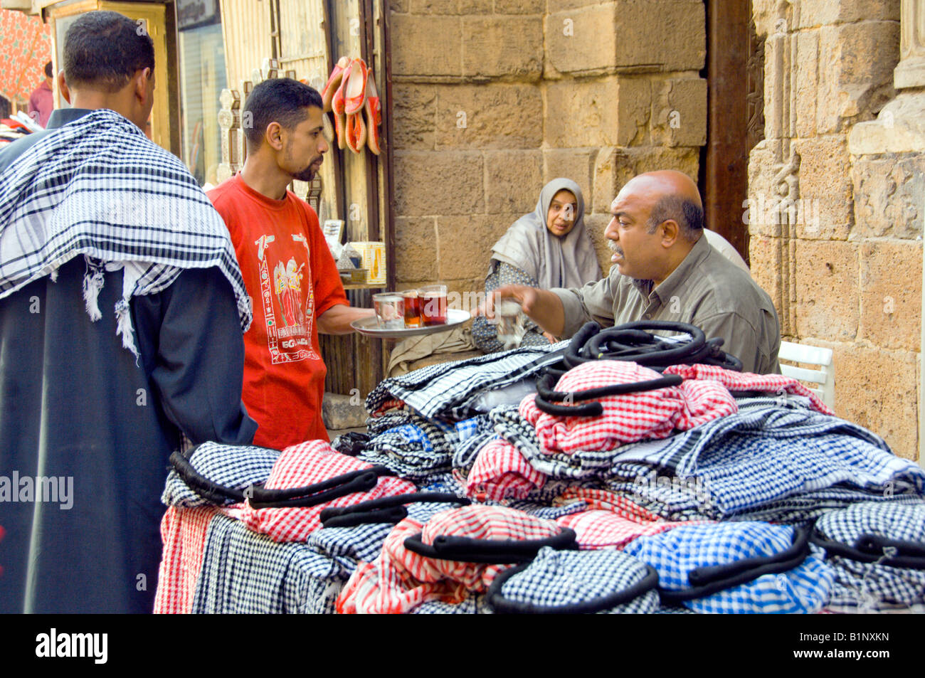 An arab shopkeeper takes a cup of tea at the Khan El Khalili market in Cairo Egypt Stock Photo