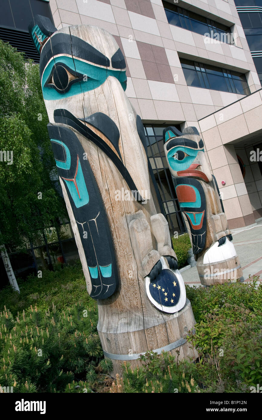 Totem poles in from of Anchorage courthouse, Alaska, USA Stock Photo
