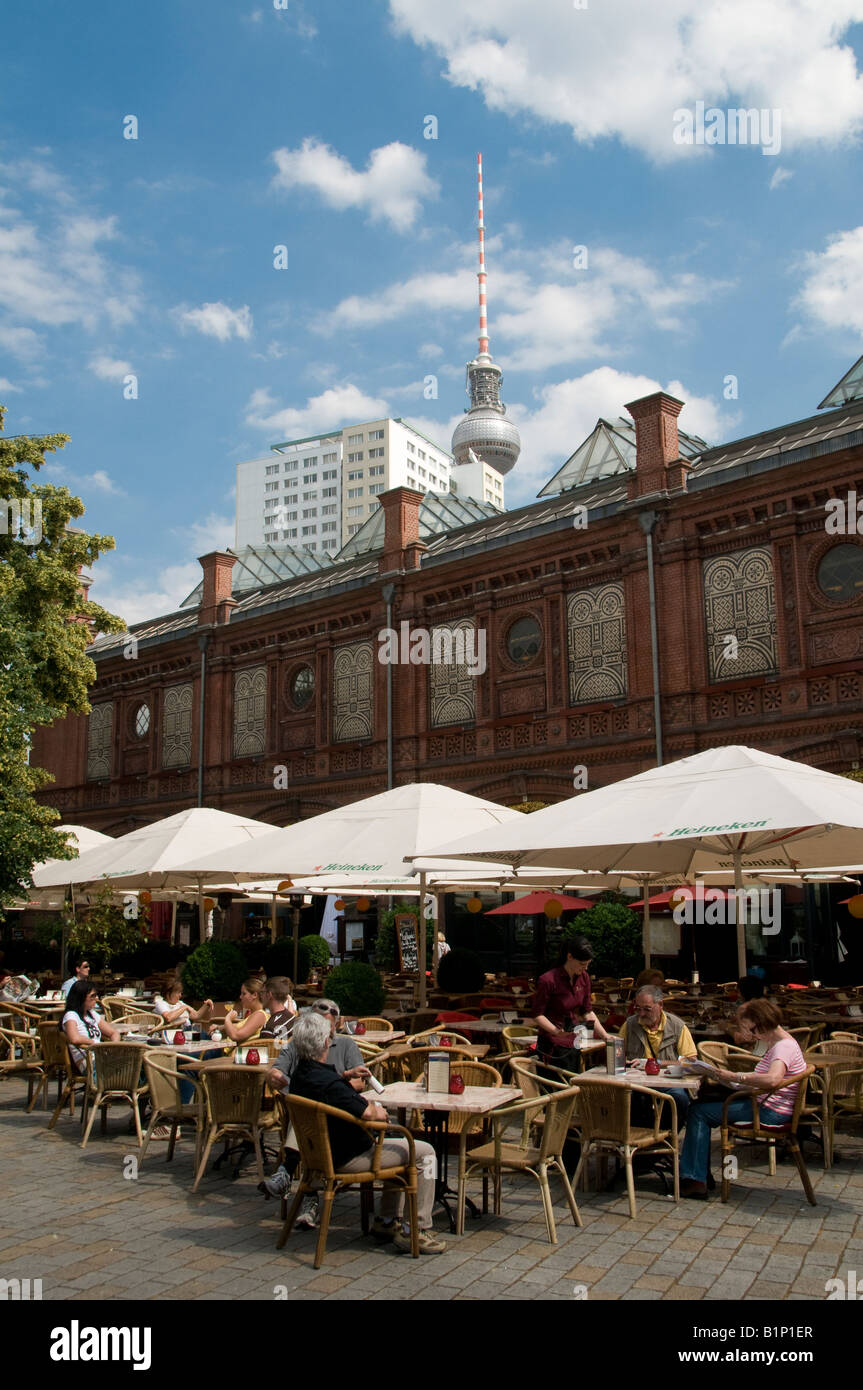 Customers dine outside at a restaurant in the Hackecher Markt rail station Berlin Germany Stock Photo