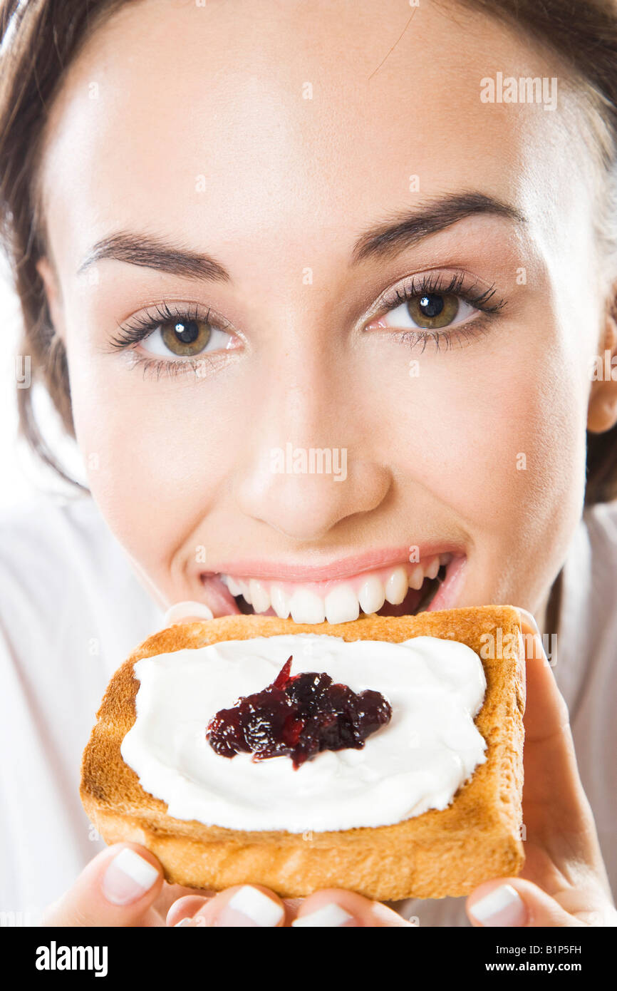Young woman eating toast Stock Photo Alamy