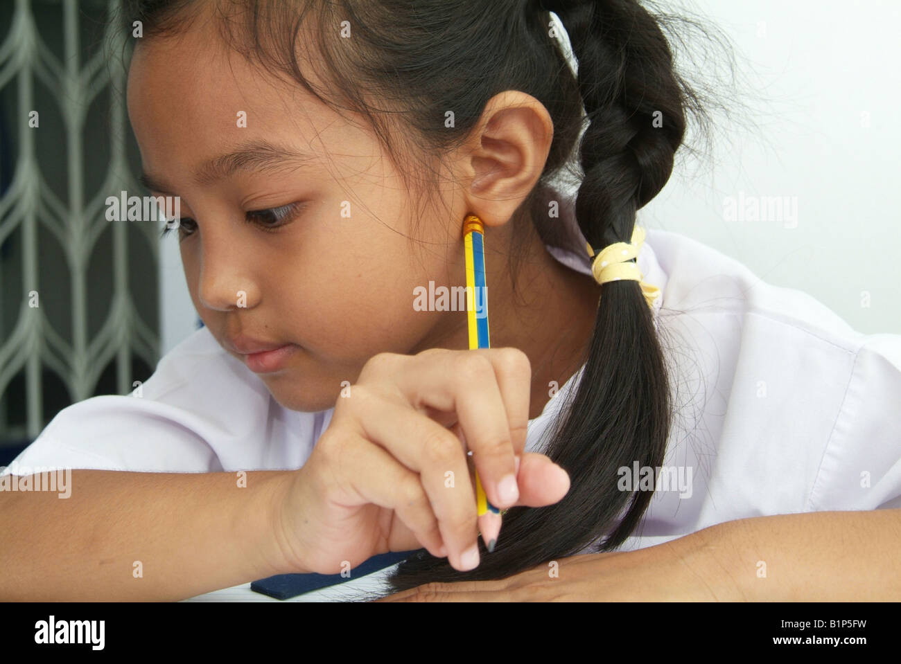 Portrait of Thai girl 8 years old in school uniform Stock Photo