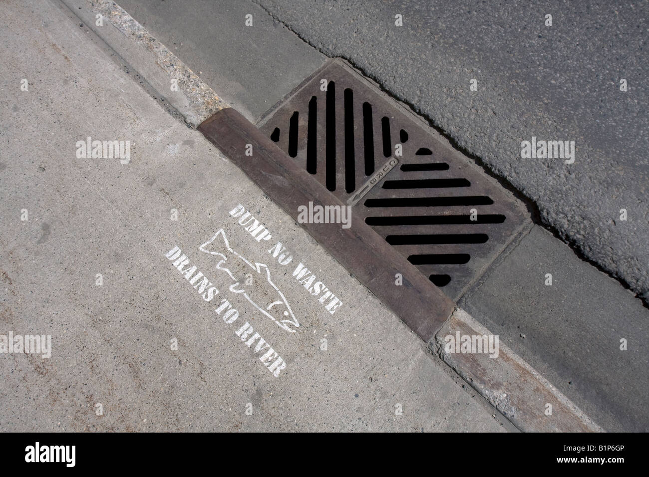 Ecology label indicating direct connection to river without sewage processing near the City Street Storm Drain system Stock Photo