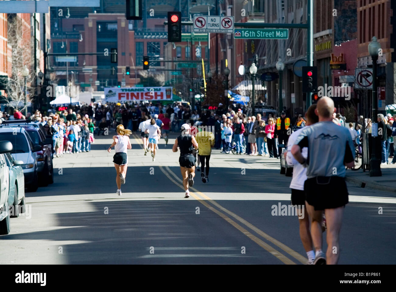Running to the Finish Line at the Running of the Green footrace held in the LoDo area of downtown Denver Stock Photo