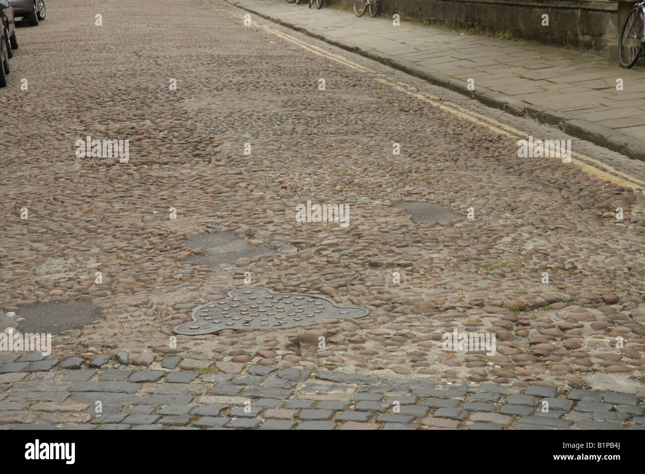 Old cobbled street with a footpath Stock Photo