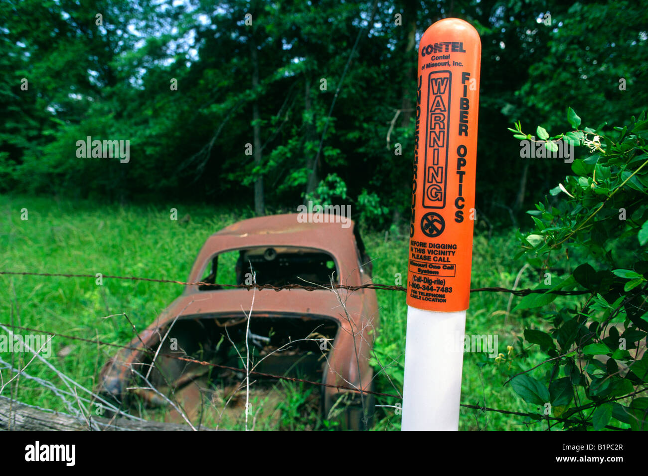 Fiber optic cable marker and a junk car, Missouri Stock Photo