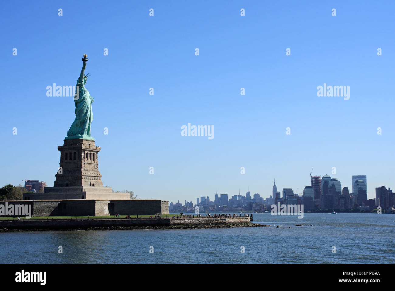 Lady Liberty on Liberty Island with Manhattan in the background - New York City, USA Stock Photo