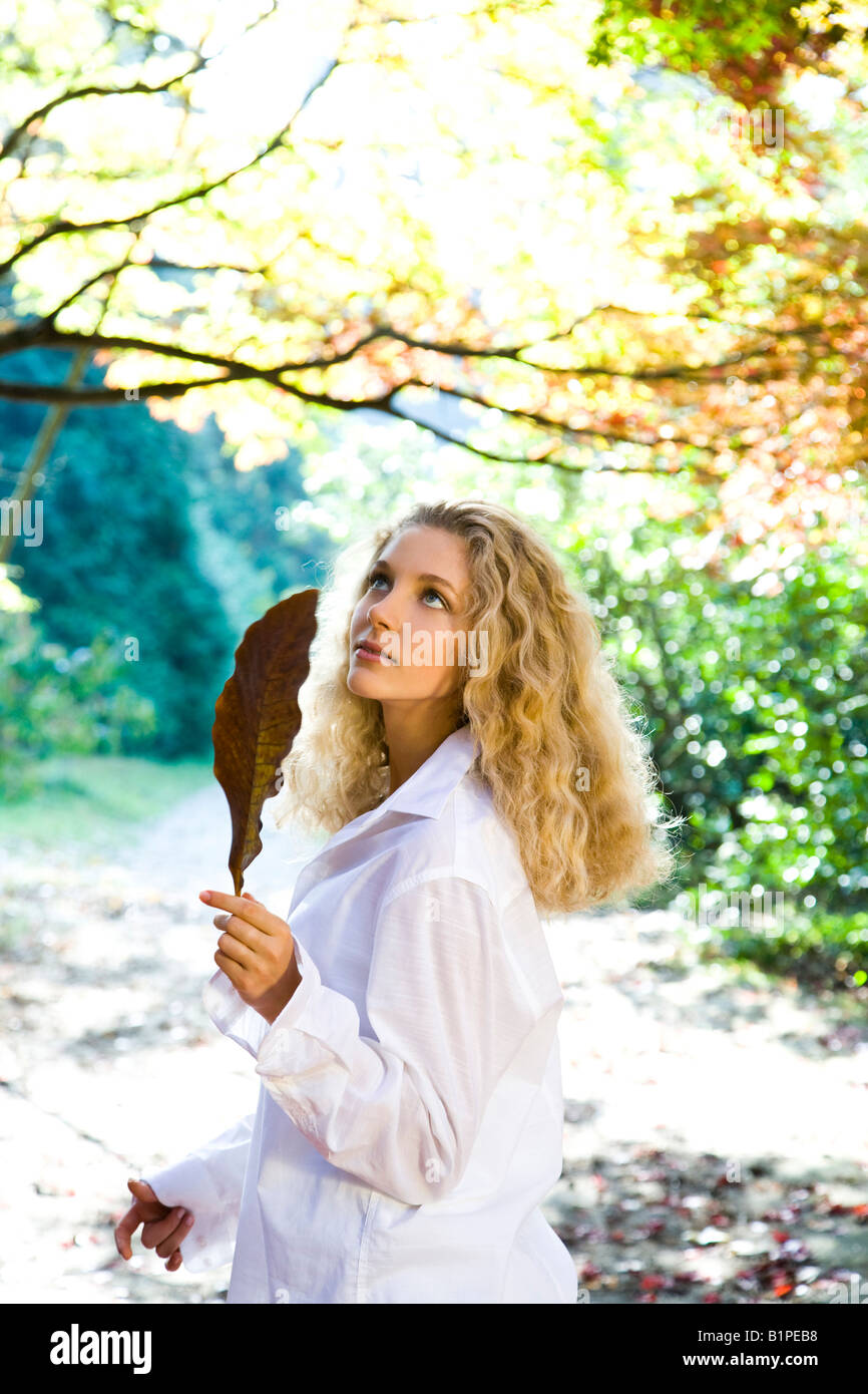 Blond woman in autumn park Stock Photo - Alamy
