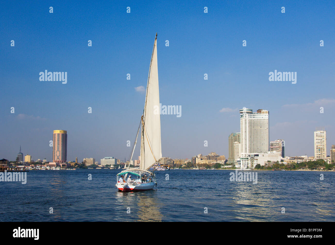 The Sofitel and the Grand Hyatt hotels and the skyline of Cairo with a felucca sailboat from the Nile River Egypt Stock Photo