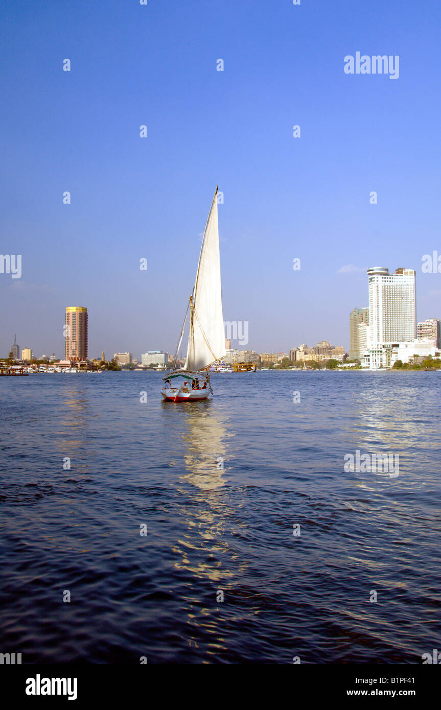 The Sofitel and the Grand Hyatt hotels and the skyline of Cairo with a felucca sailboat from the Nile River Egypt Stock Photo