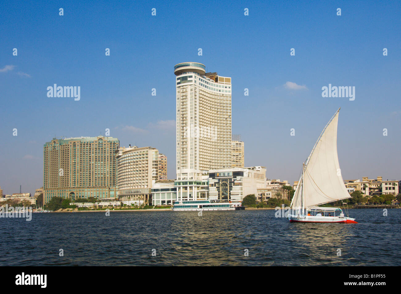 The Four Seasons and the Grand Hyatt Hotels in Cairo with a felucca sailboat on the Nile river Egypt Stock Photo