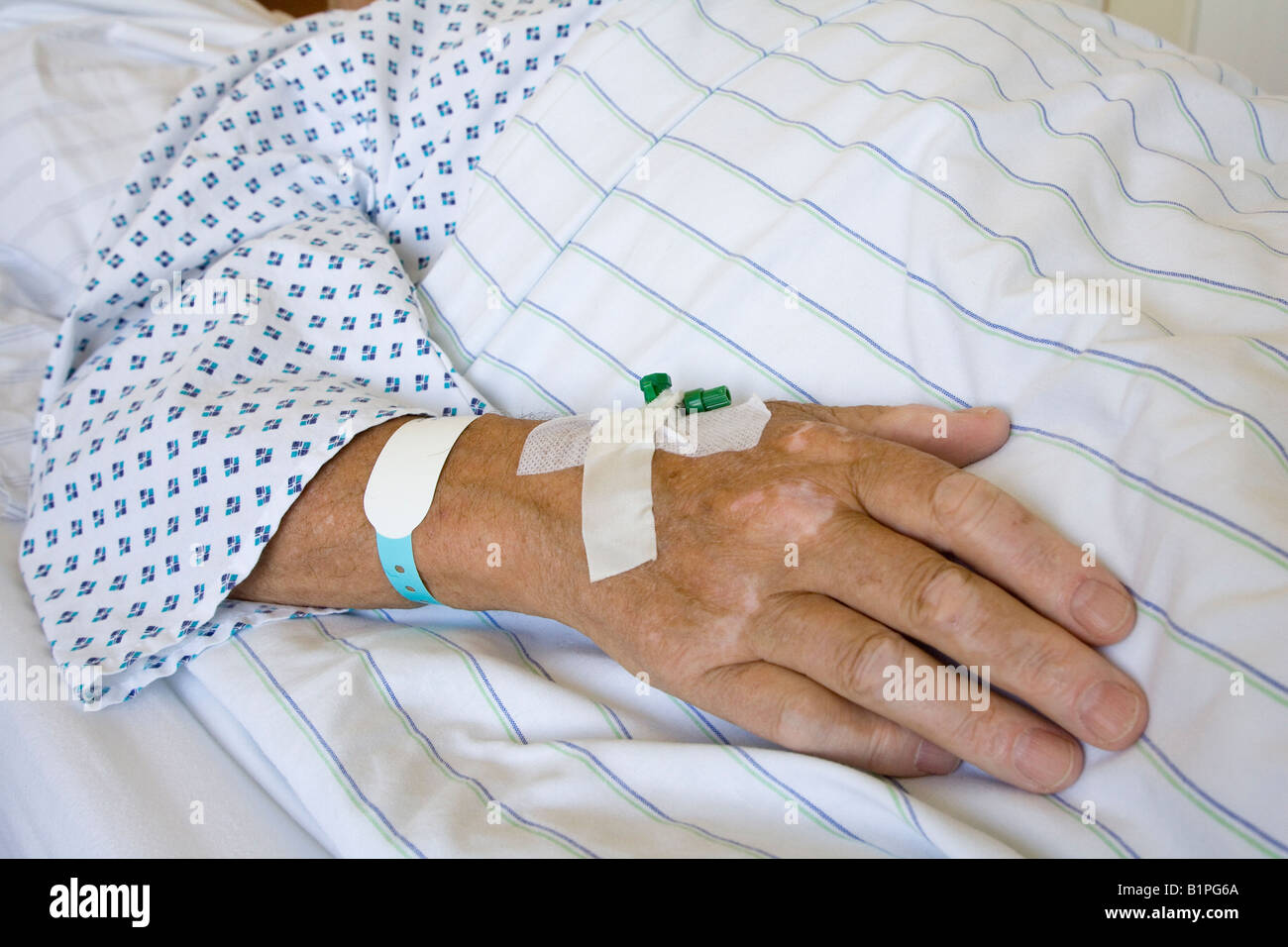 Sick senior shortly before his operation in the hospital bed for private insurance patients of the category 1st class Stock Photo