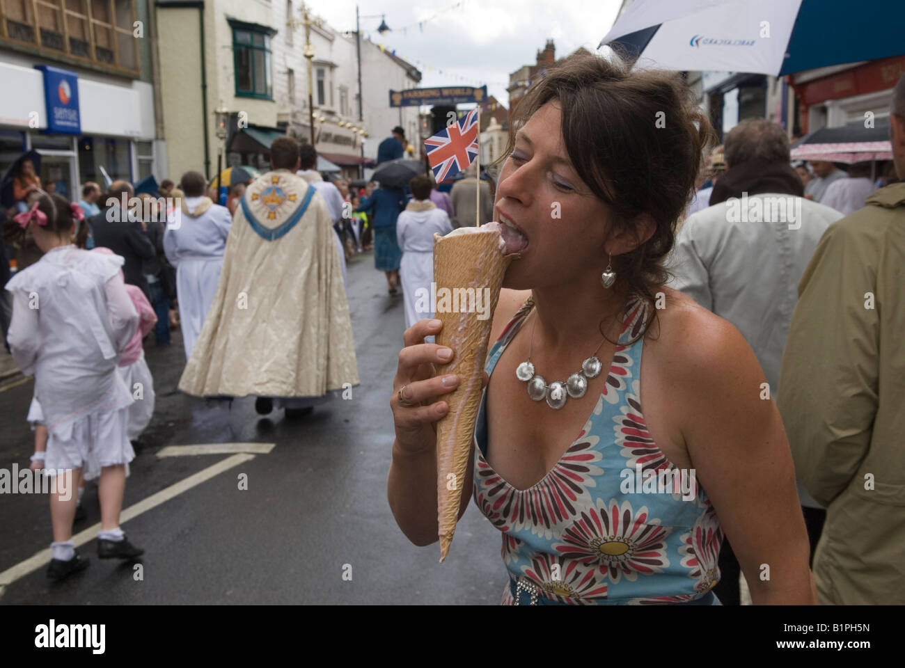 Whitstable Oyster Festival Kent England Eating large Union Jack flag