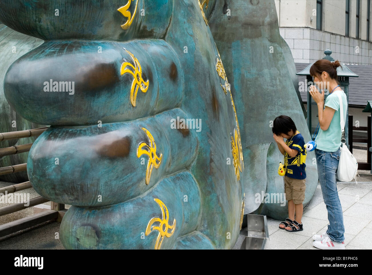 Mother And Child Praying At The Foot Of A Giant Reclining Buddha Stock Photo Alamy Mother And Child Praying At The Foot Of A Giant Reclining Buddha Stock Photo Alamy