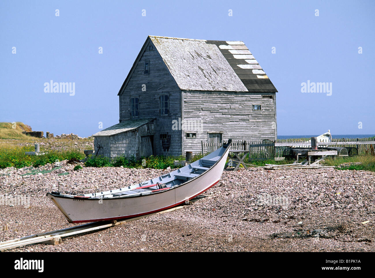 A fisherman's shack and a dory on the beach, Ile aux Marins, Saint Pierre et Miquelon Stock Photo