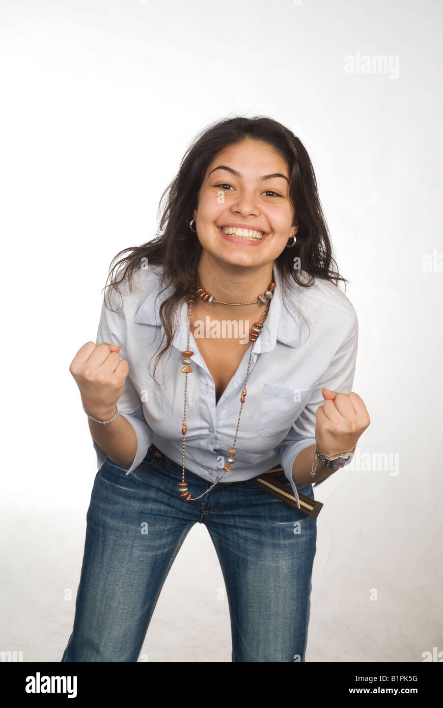 Excited Asian teenage girl standing against a white background Stock Photo