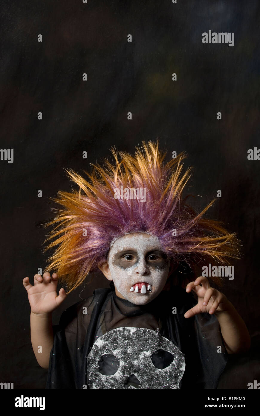 Head and shoulder portrait of a 3 years old boy wearing a scary