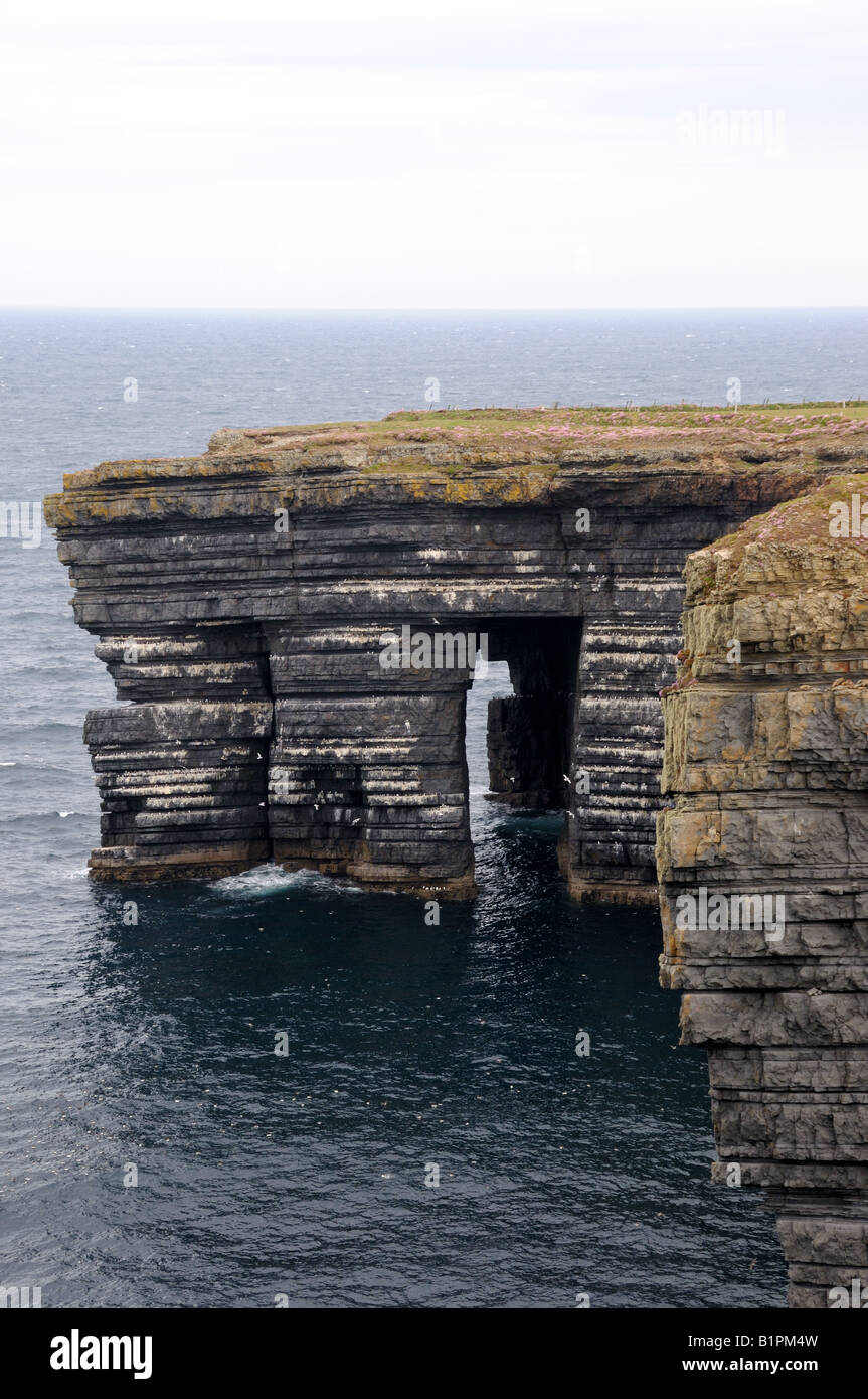 Wave erosion formed window on the rocky cliff. County Clare, Ireland. Stock Photo
