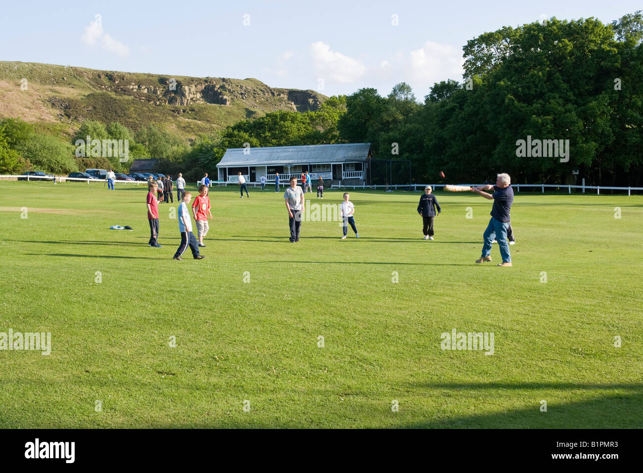 youngsters playing cricket on a rural cricket pitch Stock Photo