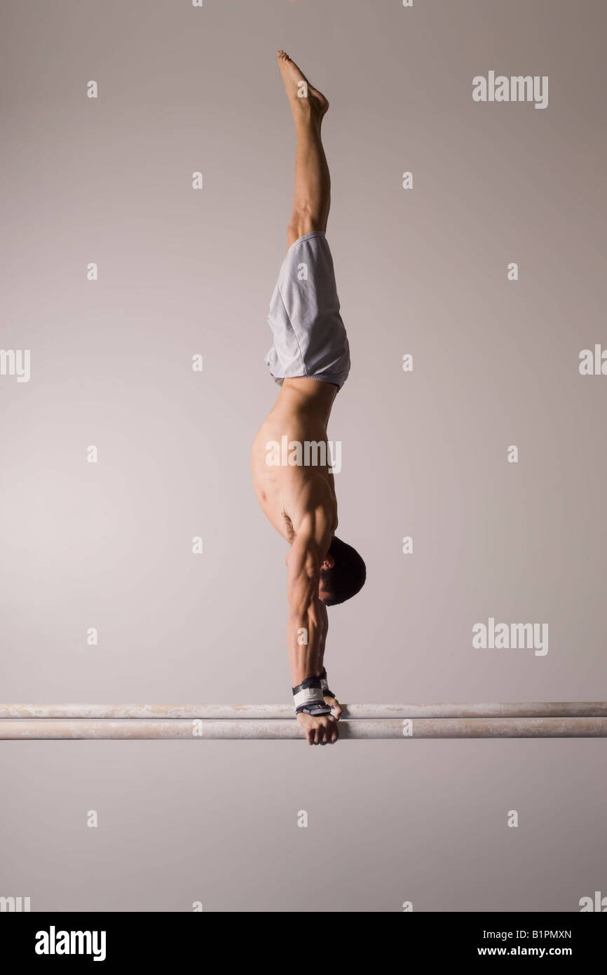 A male gymnast trains on the parallel bars Stock Photo Alamy