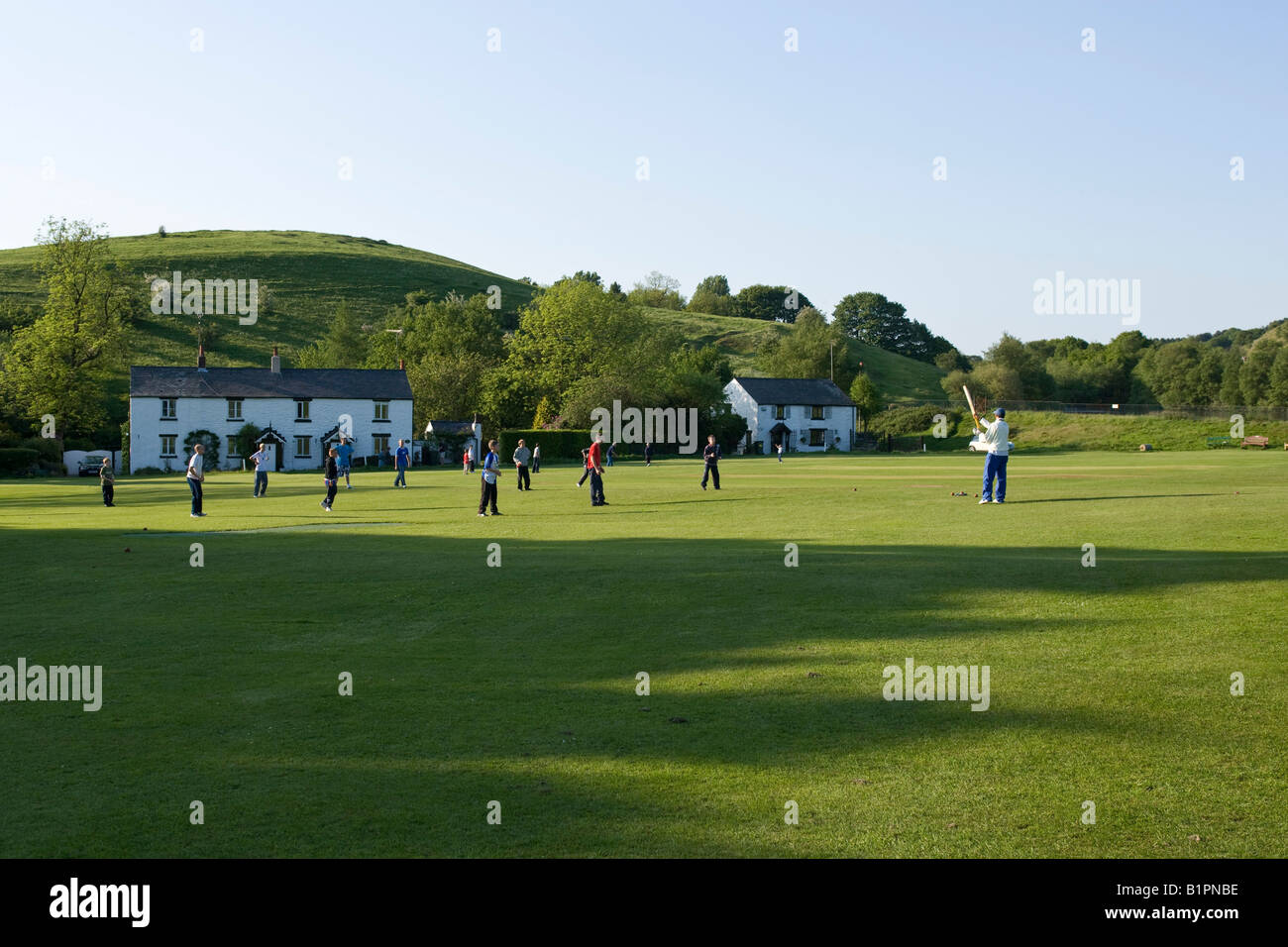youngsters playing cricket on a rural cricket pitch Stock Photo