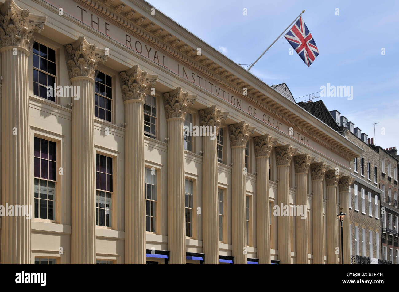 Royal Institution of Great Britain & Faraday Museum building facade at  roof level a colonnade Corinthian capitals Albemarle Street London England UK Stock Photo