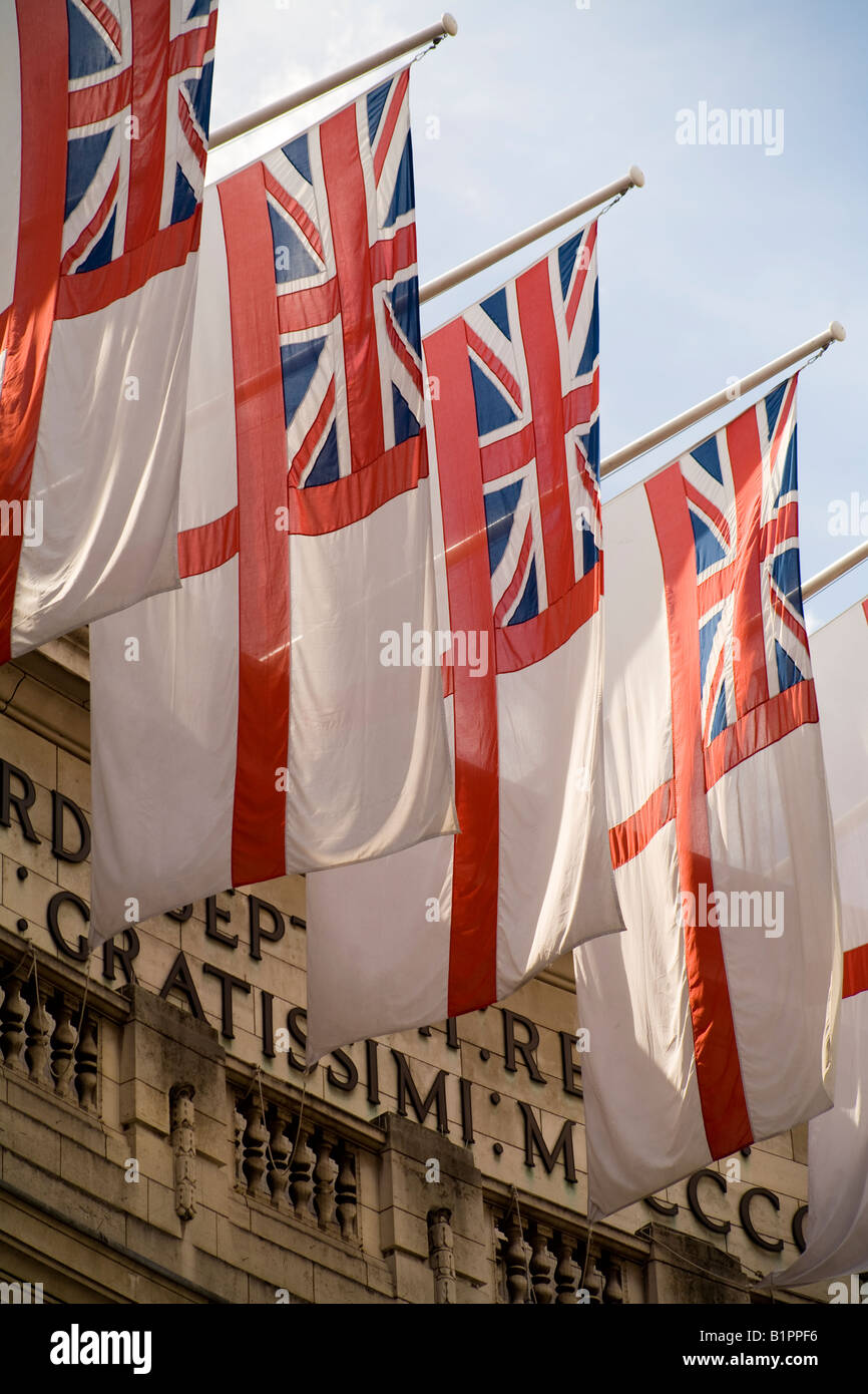 The White Ensign the flag of the Royal Navy flies from the top of Admiralty Arch in the afternoon sunshine Stock Photo