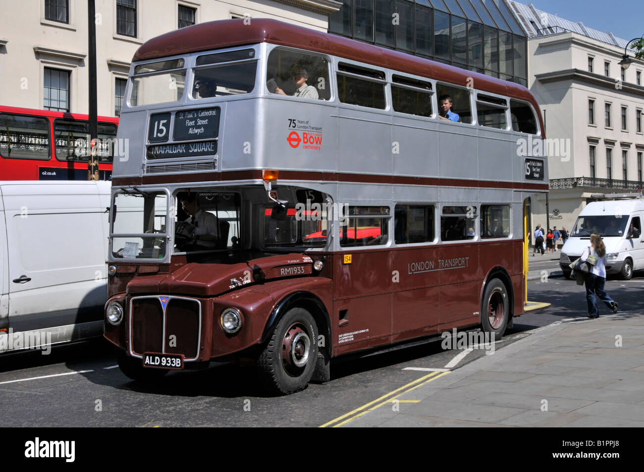 London street scene double decker bus driver & Routemaster RM1933 painted special livery commemorate 75th anniversary of London Transport Strand UK Stock Photo