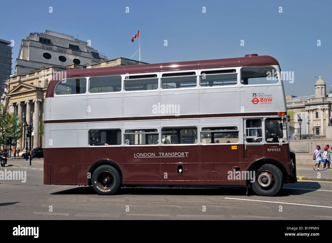 London street scene side double decker Routemaster bus RM1933 special livery commemorate 75th anniversary London Transport Trafalgar Square London UK Stock Photo