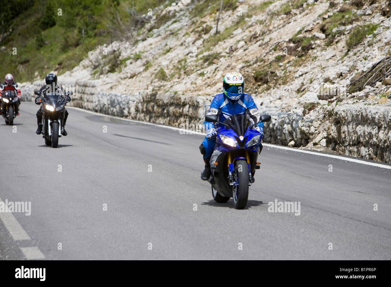 Motorbike riders climbing the Sella Joch pass in the Italian Dolomites Stock Photo