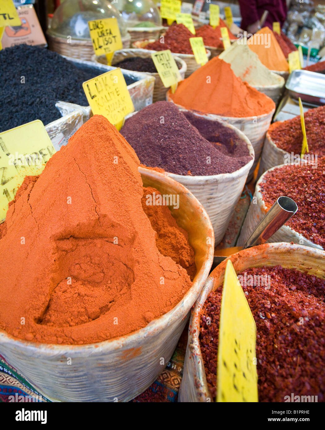 Baskets of Spices vertical Colourful orange and red spices piled high