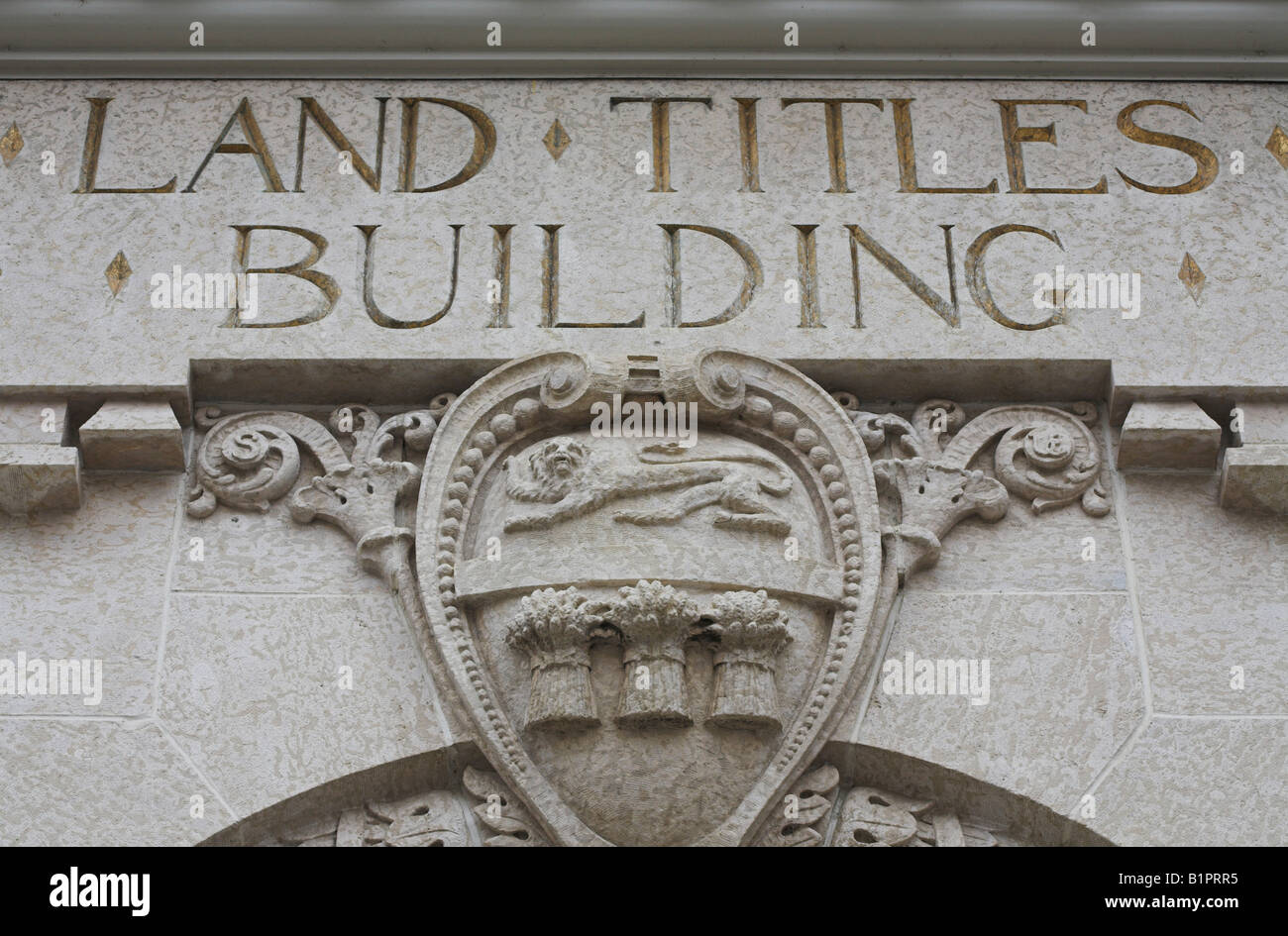 Land Titles Building The sign carved into stone and supported by an