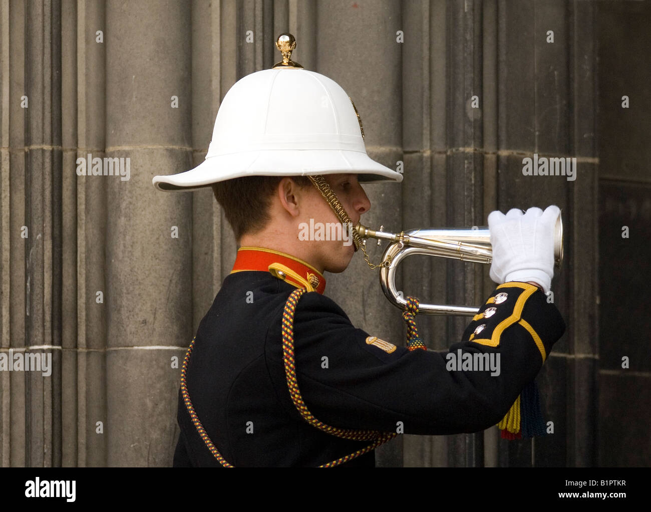 A bugler from the Royal Regiment Of Scotland plays the Last Stand on a military bugle outside St Giles' Cathedral in Edinburgh. Stock Photo