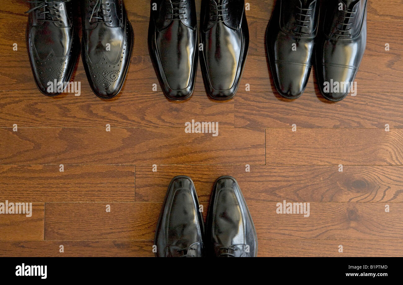 row of men's shoes face boss Stock 