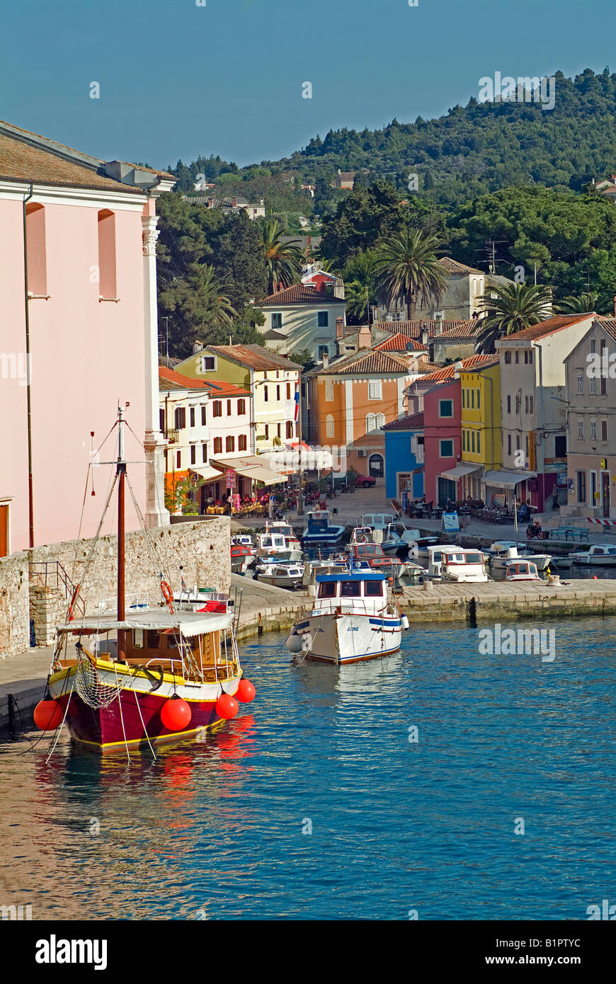 pastel coloured houses in the Port bassin with fisher boats and motor boats  in the town Veli Losinj on the island Losinj Stock Photo - Alamy