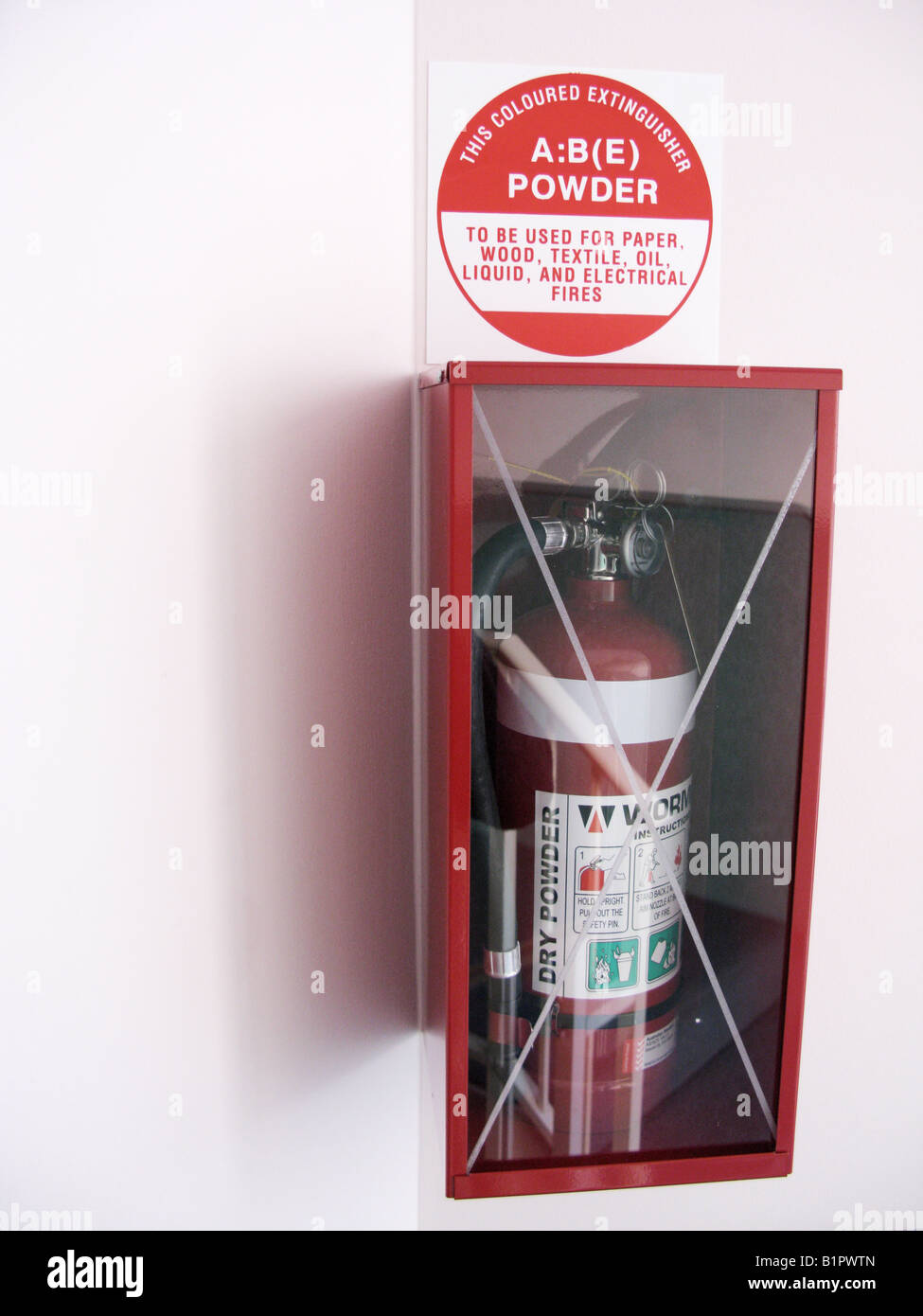 Fire extinguisher hanging on wall Stock Photo - Alamy