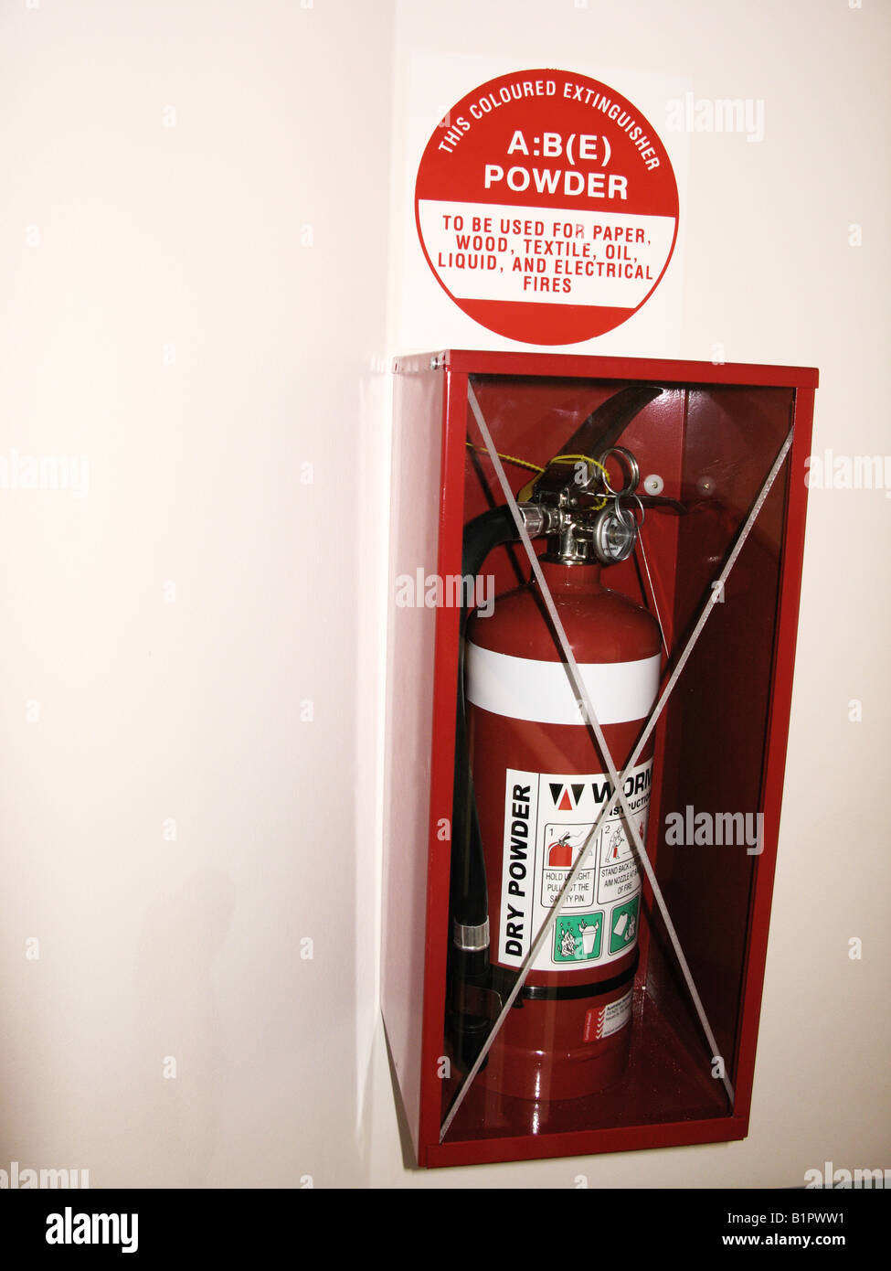 Fire extinguisher hanging on wall Stock Photo Alamy
