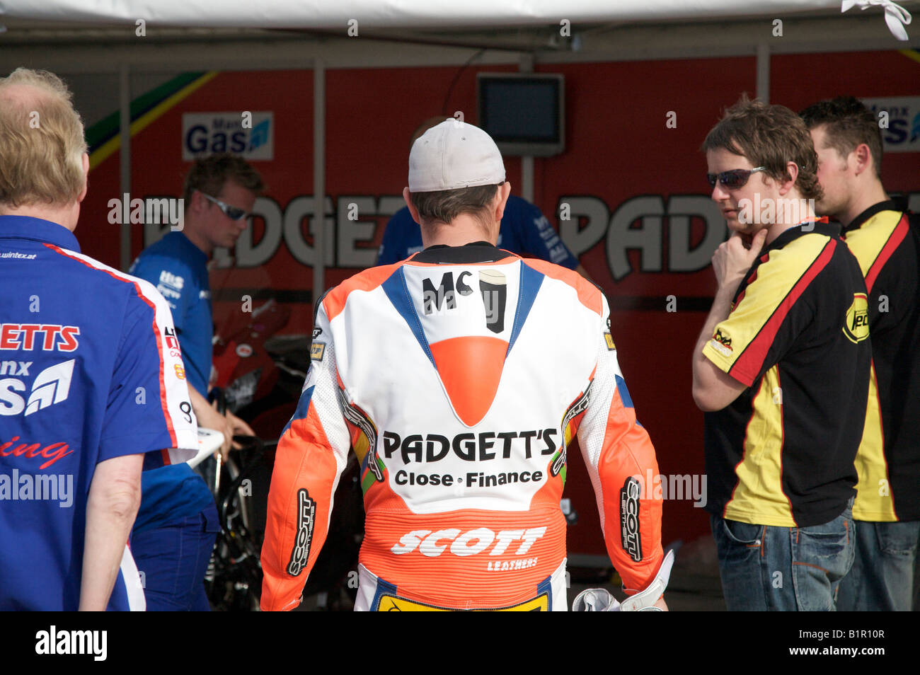 John McGuinness chats to his pit crew prior to a practice session for the 2008 Isle of Man TT races. Stock Photo