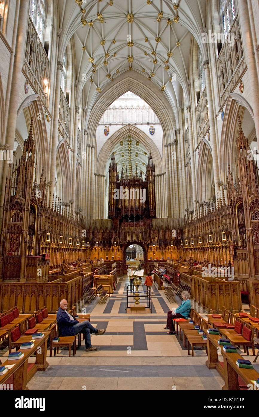 Two people sitting inside York Minster cathedral York UK Stock Photo Alamy